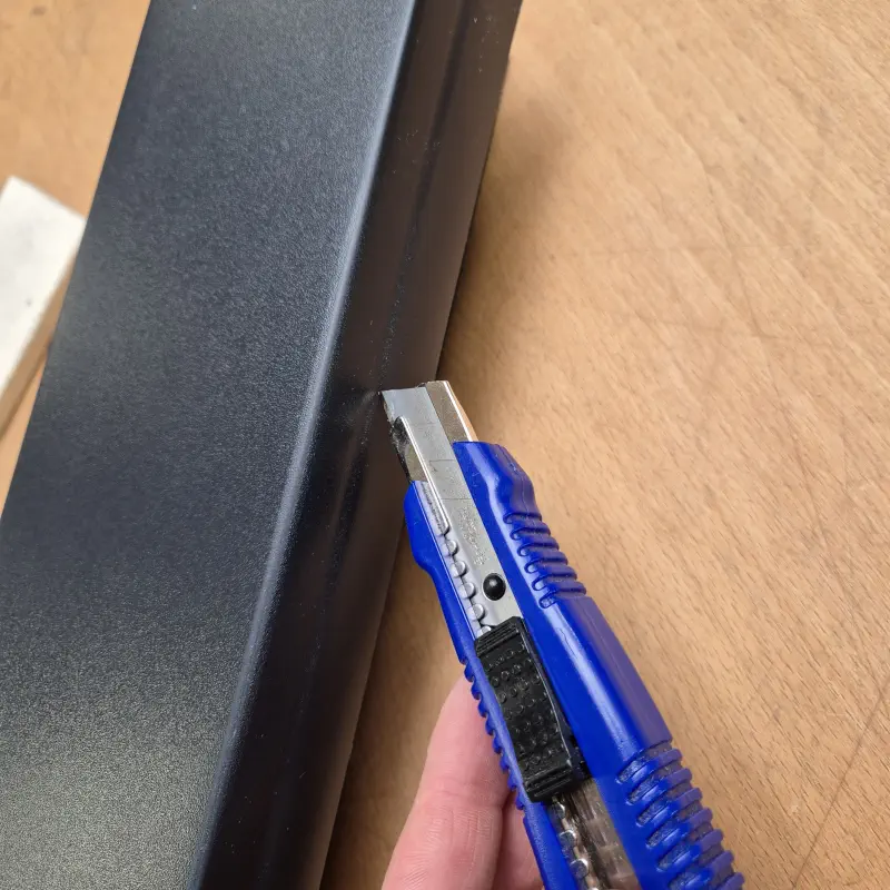 Excess film is trimmed at the profile edge with the utility knife